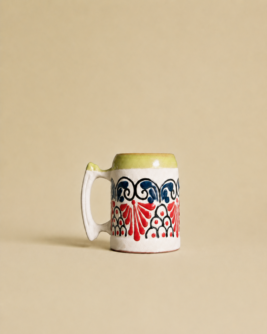 Decorative beer mug with a colorful pattern on a beige background