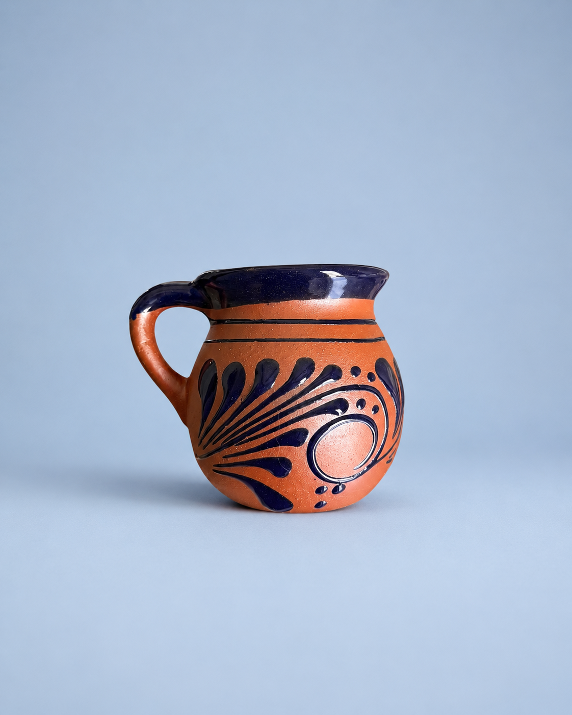 Ceramic mug with blue patterns on a light blue background