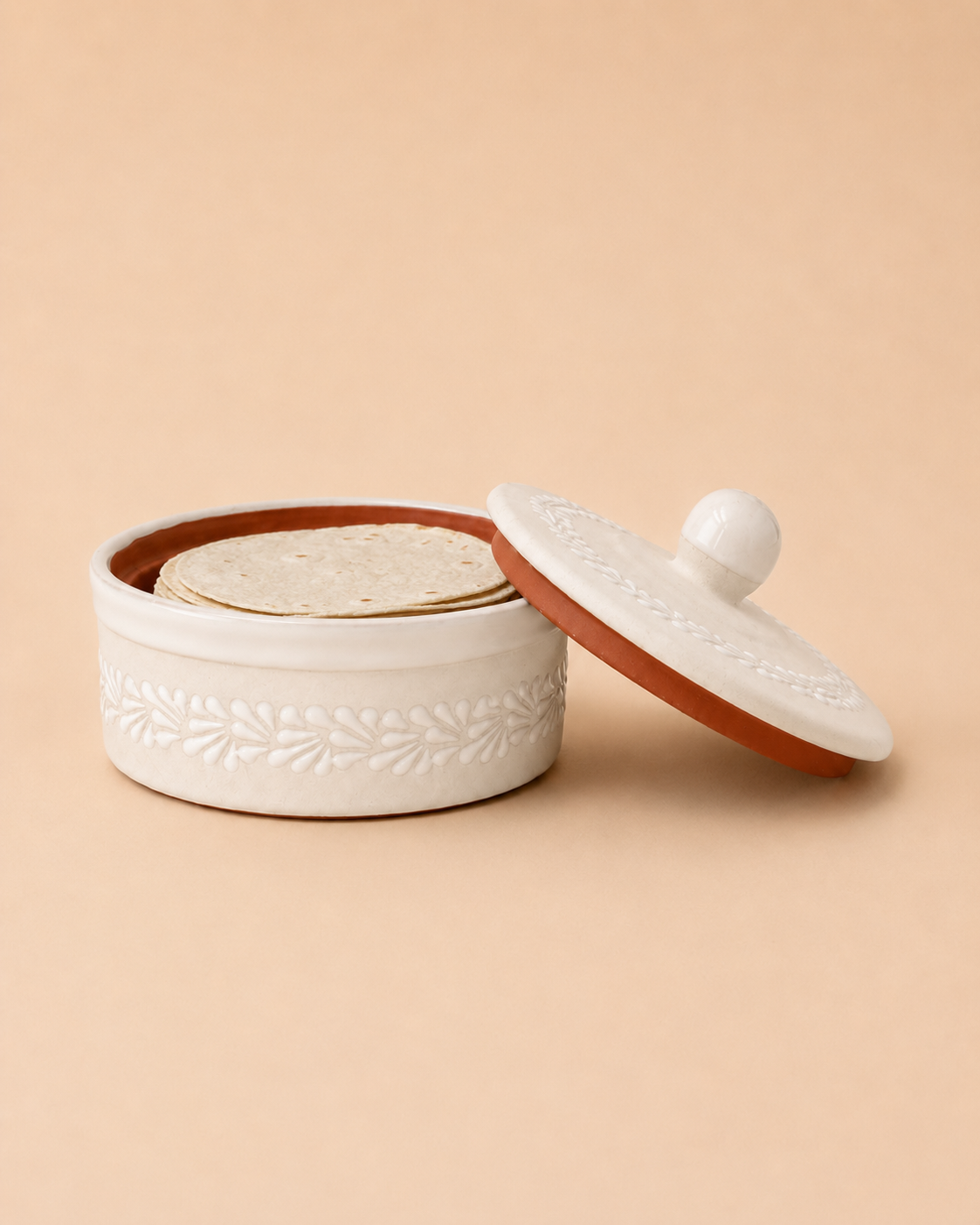 White ceramic container with a brown interior and lid on a beige background