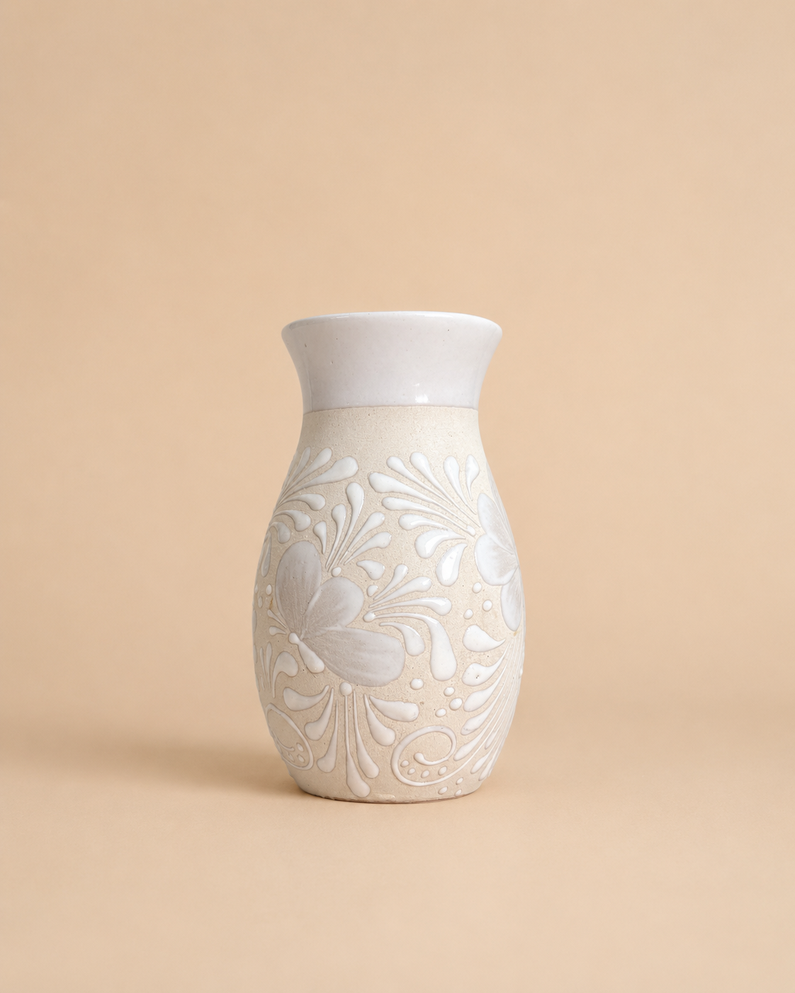 Ceramic vase with floral patterns on a beige background
