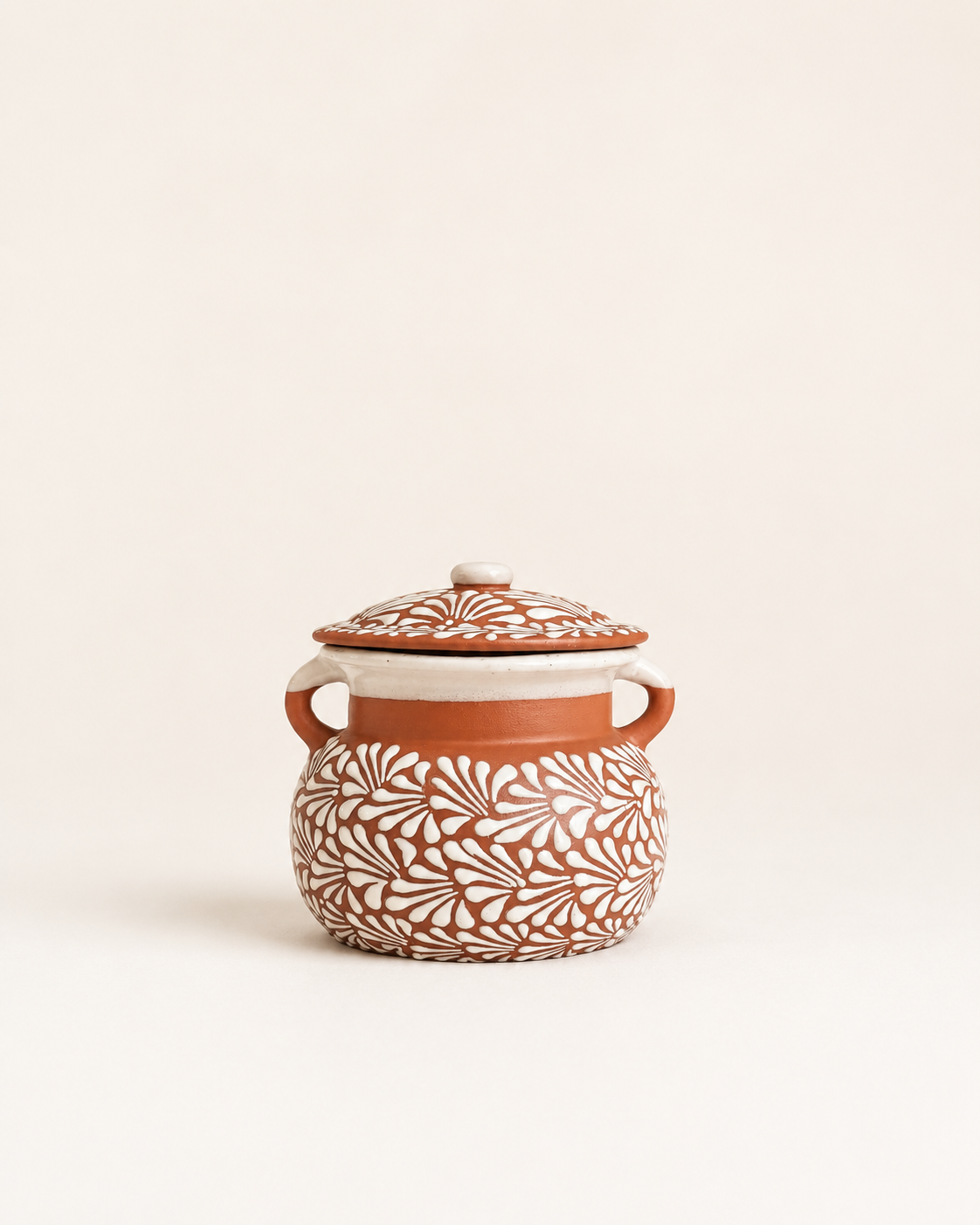 Ceramic jar with floral patterns on a beige background