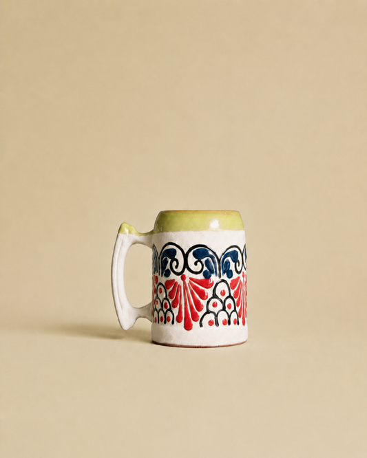 Decorative beer mug with a colorful pattern on a beige background