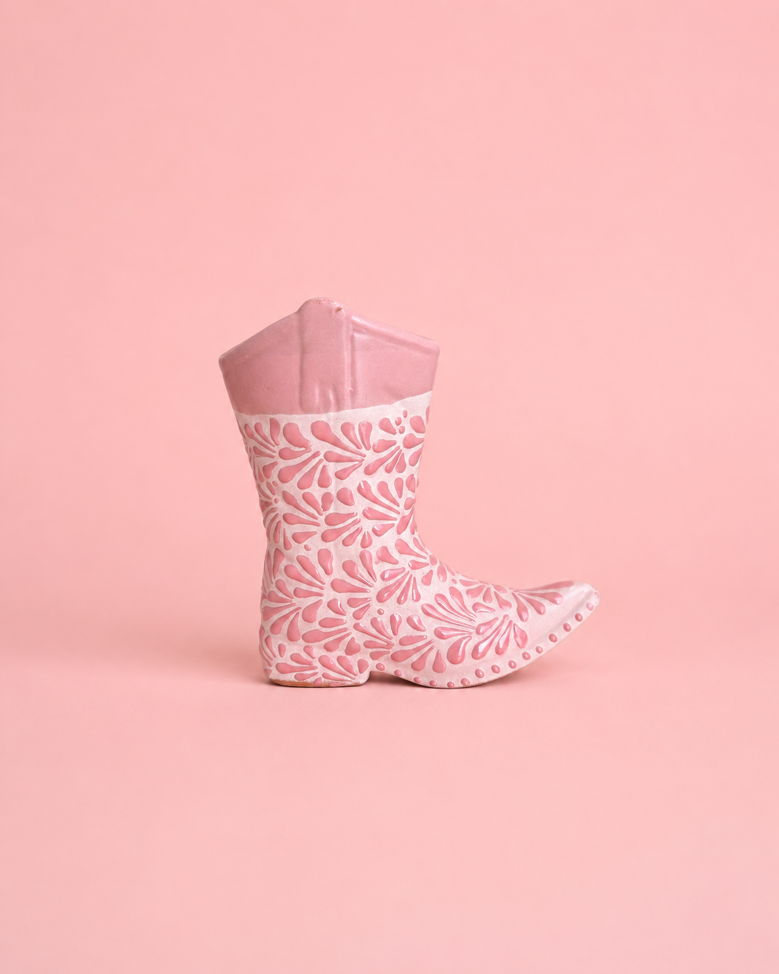 Pink floral-patterned rain boot on a pink background