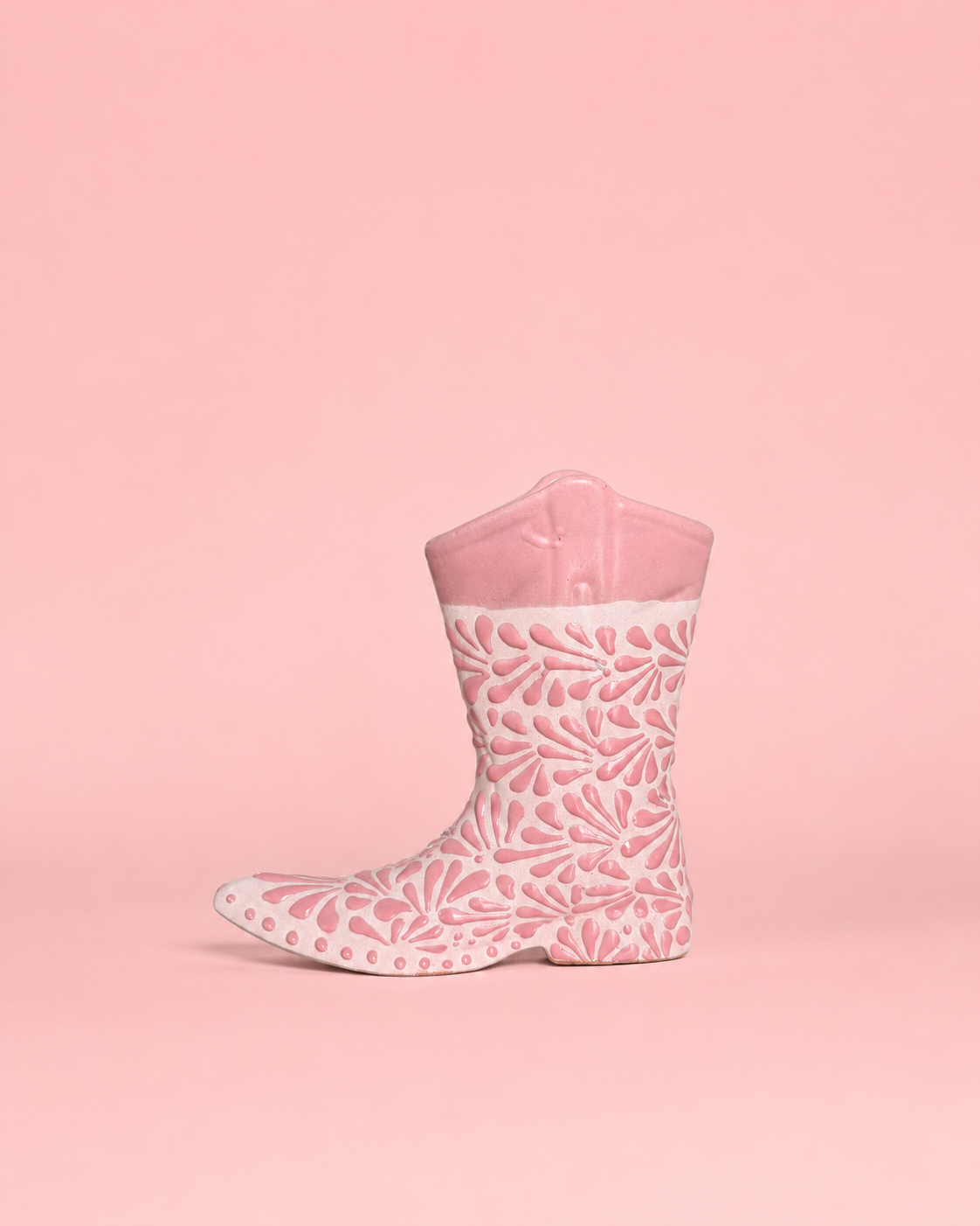 Pink ceramic boot with pink pattern on a pink background