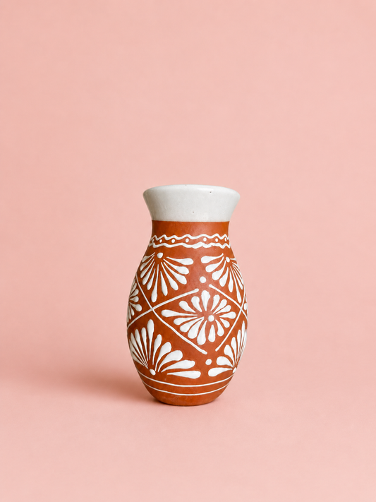 Ceramic vase with white floral pattern.