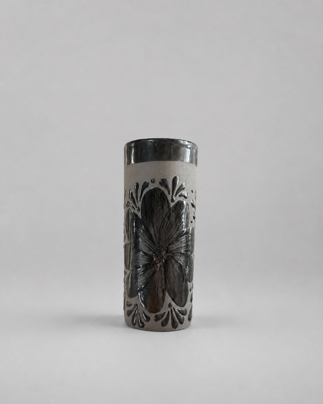 Tall cylindrical cup with butterfly design on a gray background