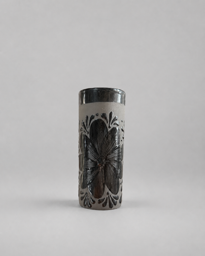 Tall cylindrical cup with butterfly design on a gray background