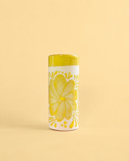Cup with flower design on a light yellow background