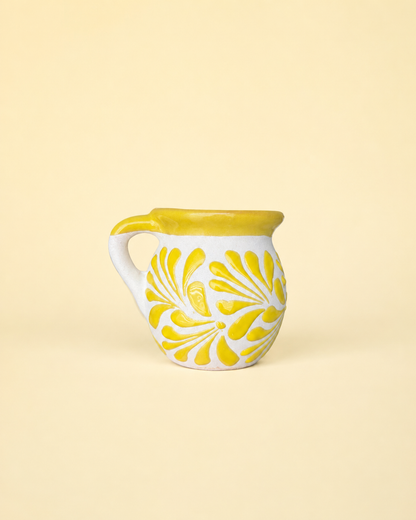 Ceramic mug with yellow floral pattern on a beige background