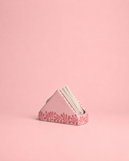 Pink napkin holder with floral pattern on a pink background