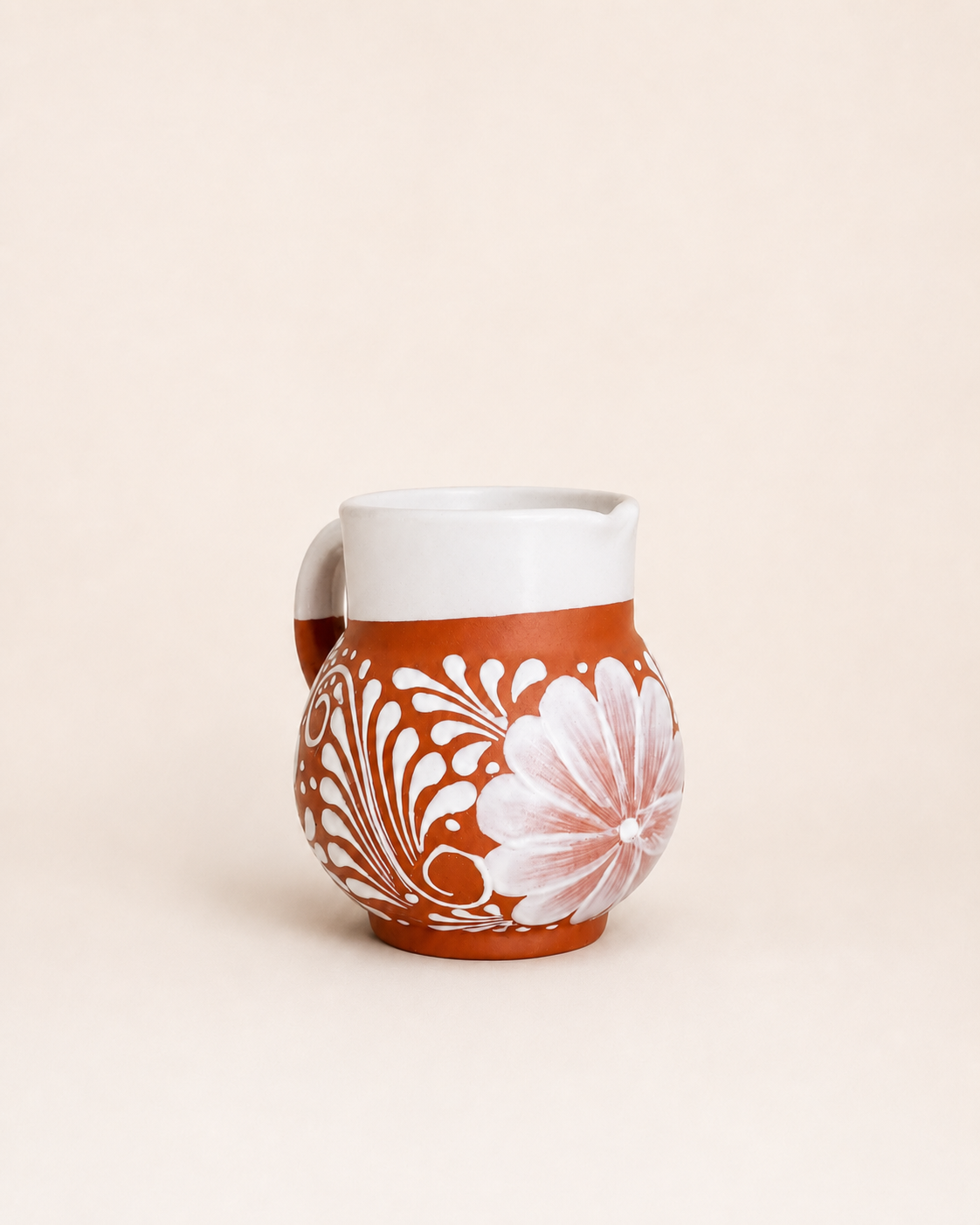 Ceramic mug with floral pattern on a beige background