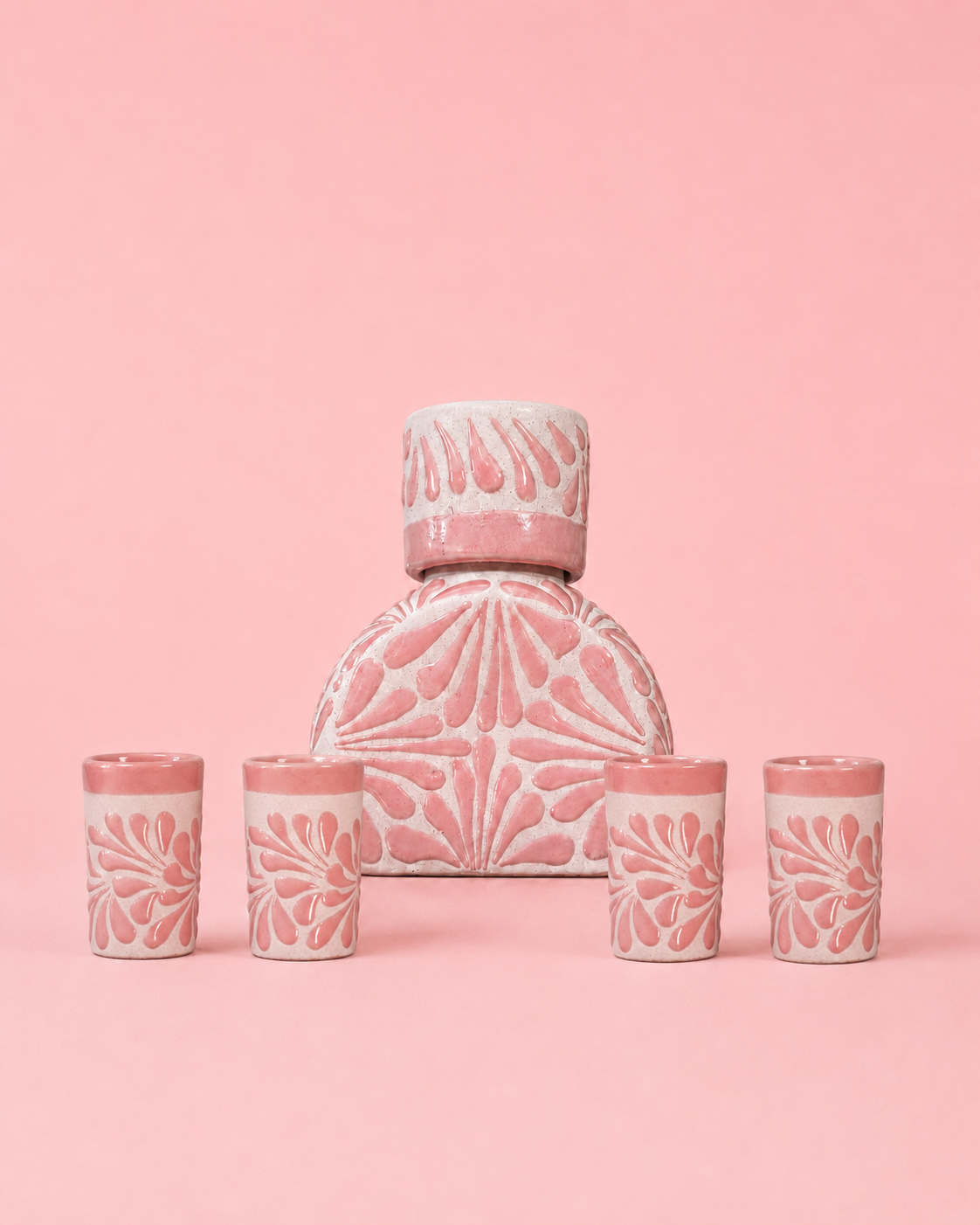 Set of pink ceramic jar with decorative patterns on a pink background