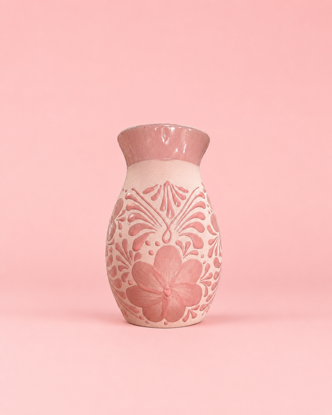 Decorative vase with floral patterns on a pink background