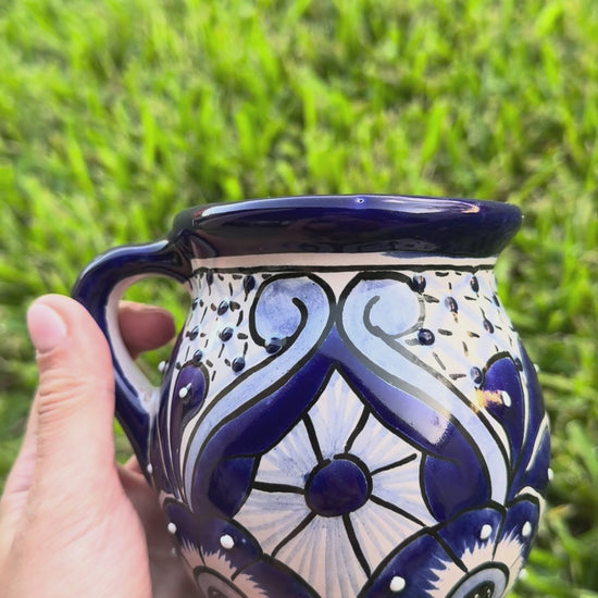 Video of 2 blue and white talavera mugs.