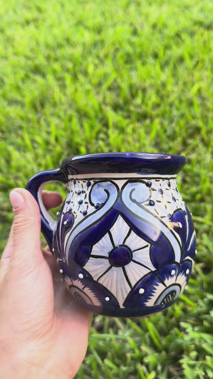 Video of 2 blue and white talavera mugs.