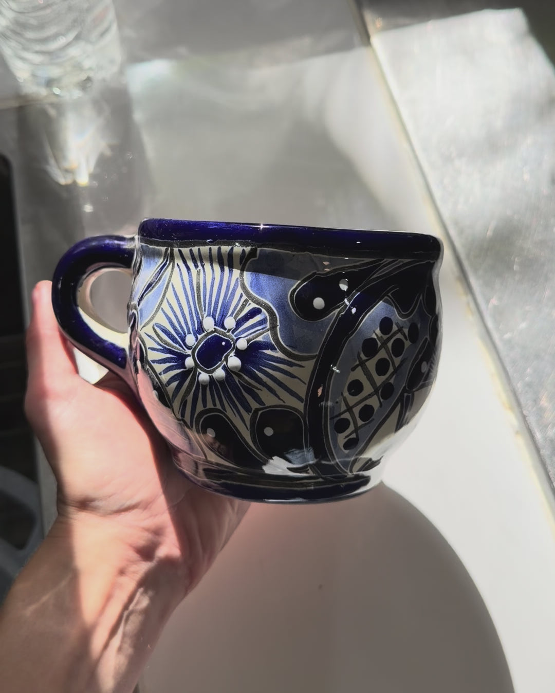 VIdeo of a blue and white talavera round mug